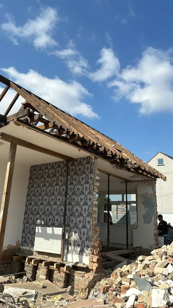 Exposed roof timbers and internal walls during demolition work in Hornchurch