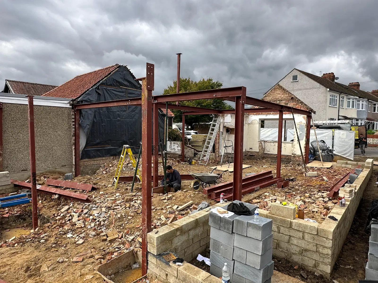 Steel columns and beams forming a structural frame above low blockwork walls