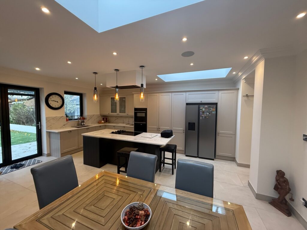 Finished kitchen and dining space with island, rooflights and glazed garden doors